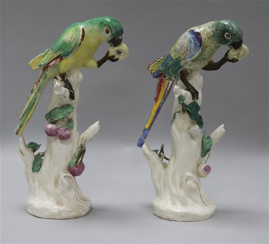 A rare pair of Naples Real Fabbrica porcelain figures of parrots on fruiting branches, early 19th century, height 26.5cm and 27cm, exte
